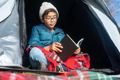 boy reading inside the tent
